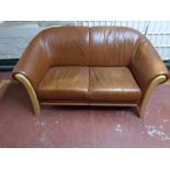 A contemporary two seater beech framed settee