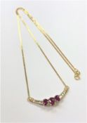 An 18ct yellow gold ruby and diamond pendant on chain,