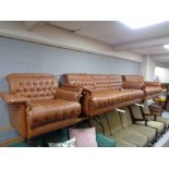 A mid century Danish brown leather three piece lounge suite comprising three seater settee,