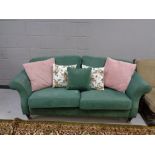 A twentieth century continental two seater settee in green fabric with scatter cushions