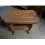 A mid century carved teak occasional table