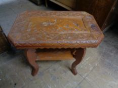 A mid century carved teak occasional table