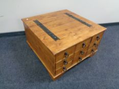 A pine storage coffee table with metal mounts