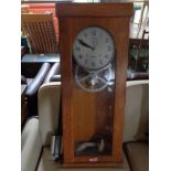 An early twentieth century oak cased time keeping machine by Benzing