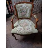 A reproduction tapestry seated armchair