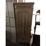 An antique pine single door cabinet