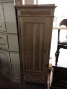 An antique pine single door cabinet