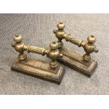 A pair of 19th century brass fire dogs