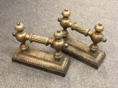 A pair of 19th century brass fire dogs