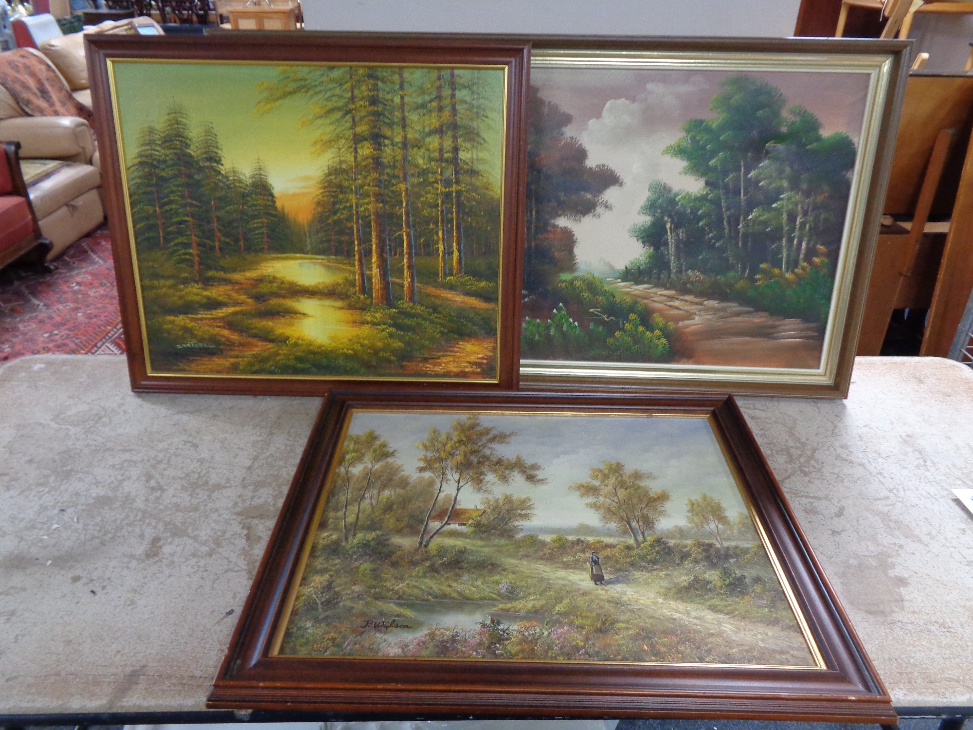 Three oil paintings depicting landscapes