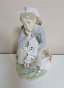 A Lladro figure, a young girl with doll.
