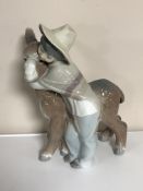 A Lladro figure of a child and donkey