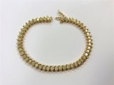 A gold diamond line bracelet, set with 50 brilliant cut stones,