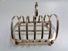 A large silver toast rack by Walker and Hall, 448.4g.