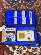 A Nintendo Game Boy in carry bag and a quantity of games.