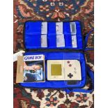 A Nintendo Game Boy in carry bag and a quantity of games.