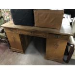 An early twentieth century oak pedestal desk