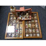 A collection of teddy bear figures in two display cases and a further display stand with miniature