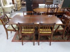 A mahogany pedestal pull out dining table with internal leaf and six chairs