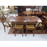 A mahogany pedestal pull out dining table with internal leaf and six chairs