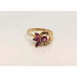 An 18ct gold ruby and diamond ring, size P/Q.