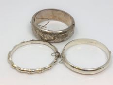 Three silver bangles.