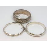 Three silver bangles.