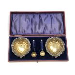 A nice pair of antique silver gilt heart shaped salts and spoons, Birmingham marks.