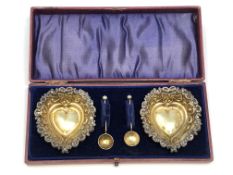 A nice pair of antique silver gilt heart shaped salts and spoons, Birmingham marks.