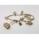 A 9ct gold bracelet mounted with charms,
