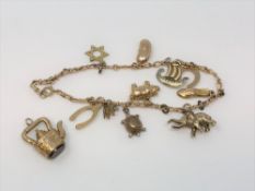 A 9ct gold bracelet mounted with charms,