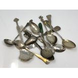 A collection of silver spoons and other items.
