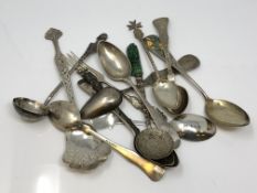 A collection of silver spoons and other items.