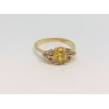 An 18ct yellow gold citrine and diamond ring, size O.