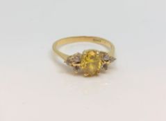 An 18ct yellow gold citrine and diamond ring, size O.