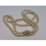 A good double 16 inch strand of pearls with pearl and gold catch CONDITION REPORT: