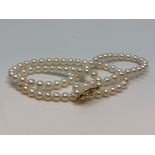 A 20 inch pearl necklace on gold clasp