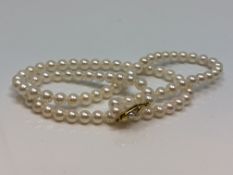A 20 inch pearl necklace on gold clasp