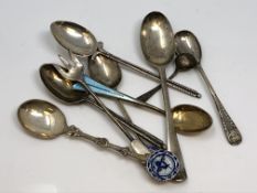 A collection of silver spoons including David Andersen enamel, early Irish example etc.