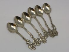 Six ornate silver teaspoons