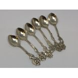 Six ornate silver teaspoons