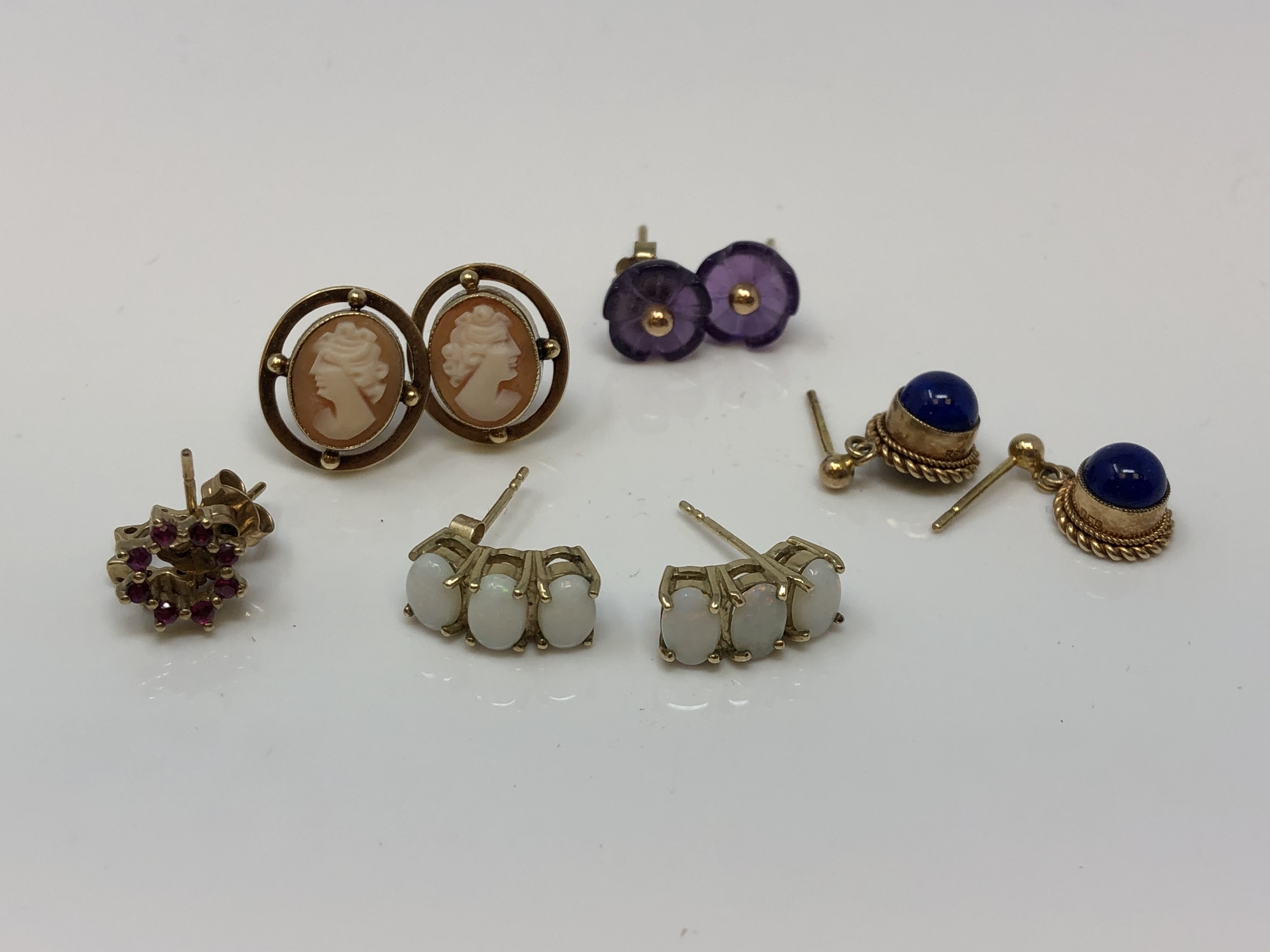 Four pairs of gold earrings set with cameo, opals,