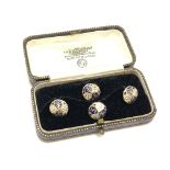 A set of 4 gold white and black enamel studs, 4.25g.