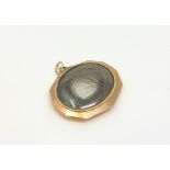 A Victorian mourning locket with hair insert.