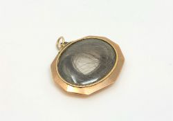 A Victorian mourning locket with hair insert.