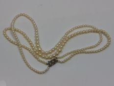A good double strand of pearls on gold and diamond clasp CONDITION REPORT: Pearks