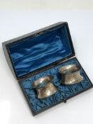 A boxed pair of ornate silver napkin rings