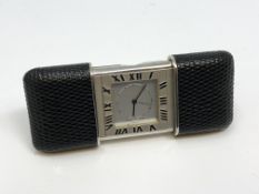 A Purse/Travel Alarm Watch by Tiffany & Co, quartz battery movement, silvered dial signed,