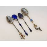 Four ornate silver and enamel spoons.