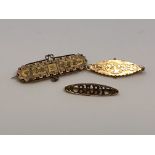 An antique gold 'baby' brooch together with two further similar brooches, 6.35g.